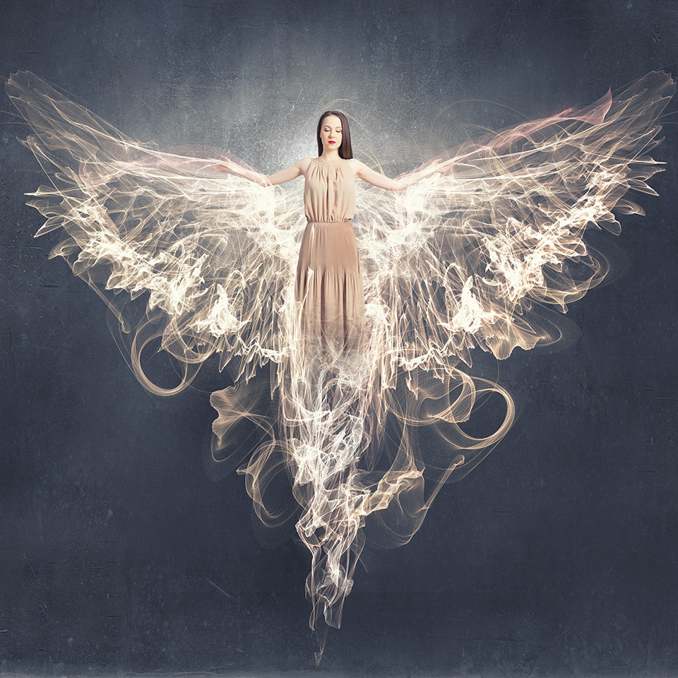 Woman with angel wings on a sky background